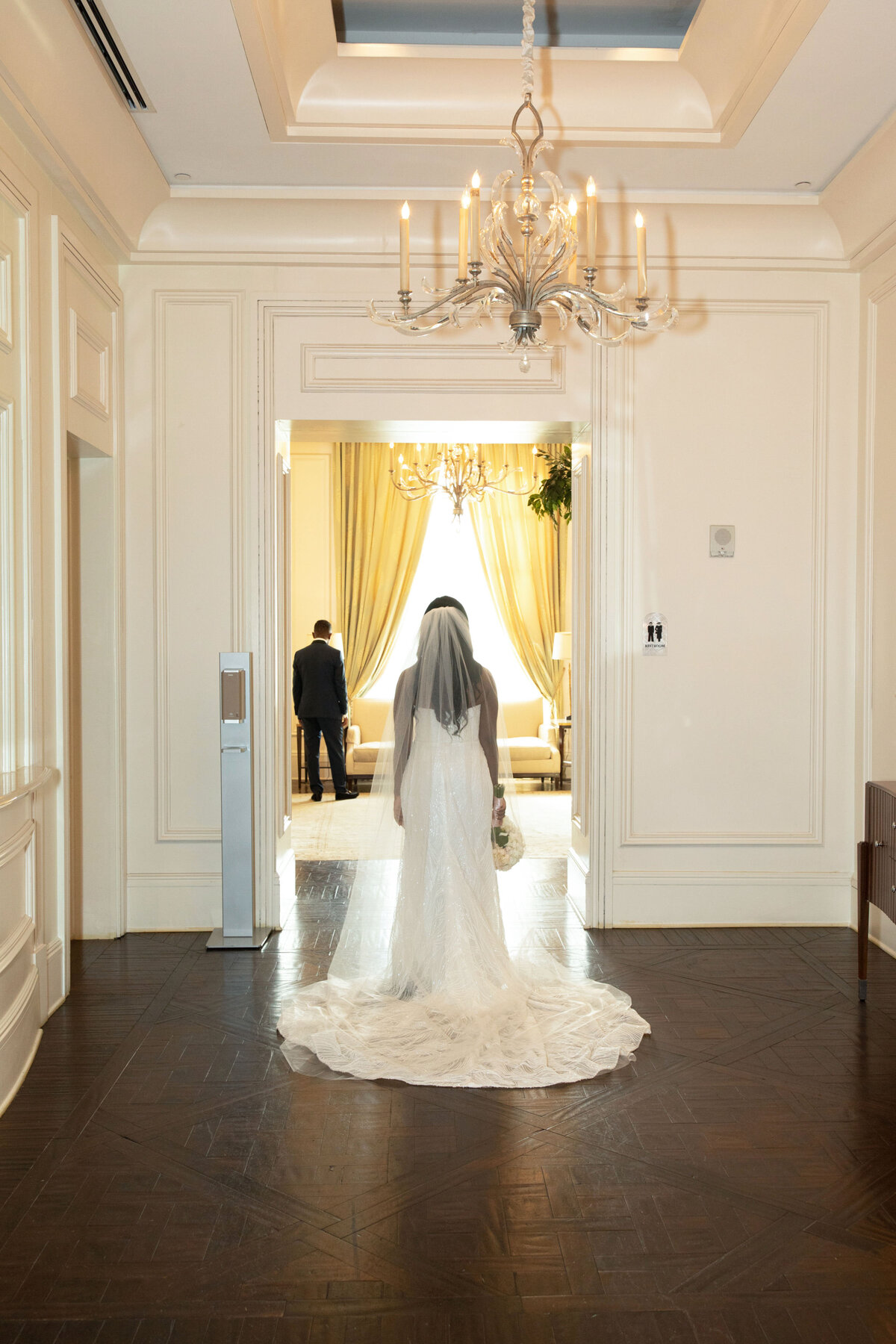 st-regis-atlanta-wedding-first-look-bride-walking-toward-groom