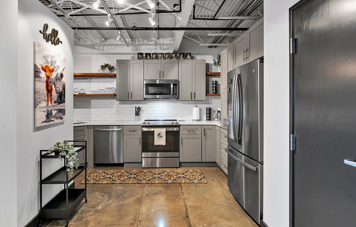 Fully stocked kitchen in this top floor two-story industrial condo in the historic Behrens building with skyline views, fully stocked kitchen and room for 6 in downtown Waco, TX.