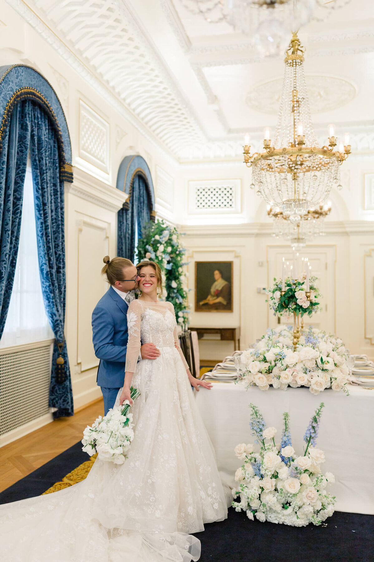 Groom kissing bride's cheek at DAR Constitution Hall in Washington DC. Captured by Washington DC Wedding Photographer Bethany Aubre Photography.