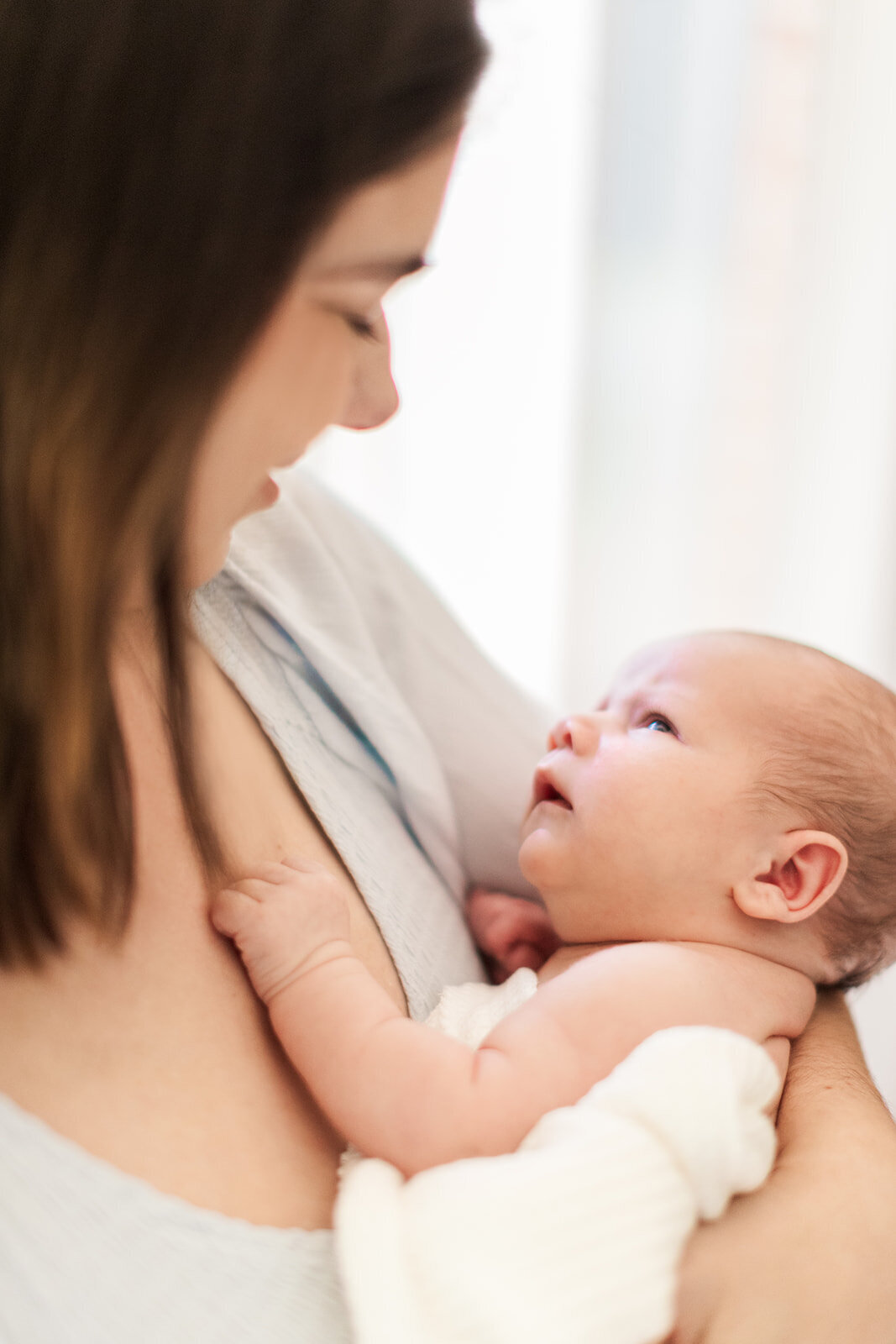 In-home newborn photos capturing connection and love