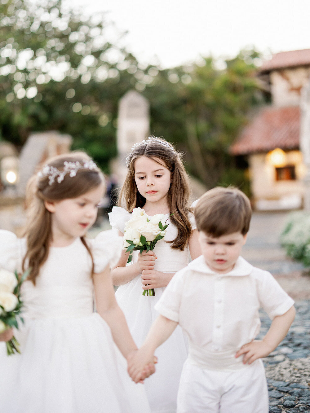 Flower girls and ring bearers walking down the aisle at a destination wedding