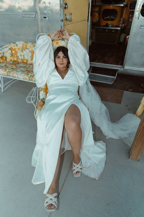 Bride-lying-back-on-lounge-chair-during-laidback-Hicksville-Trailer-Palace-wedding-reception.jpg