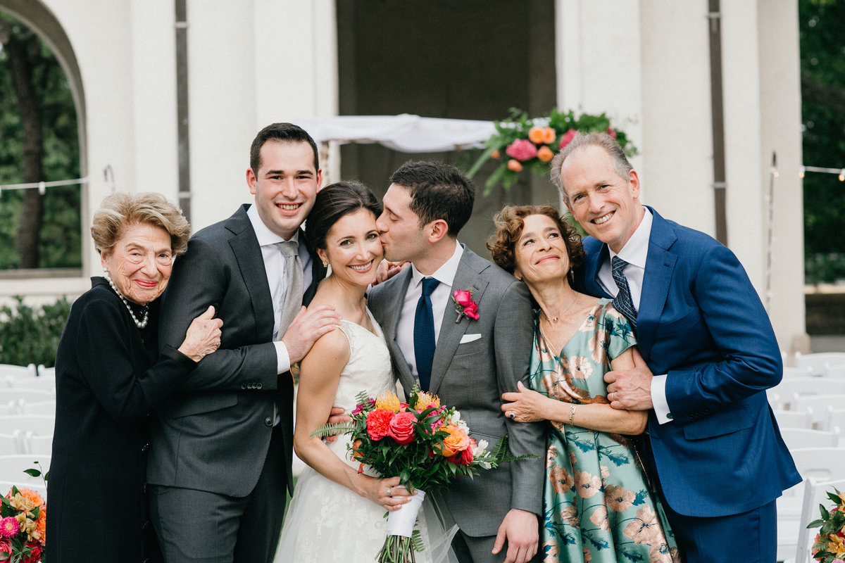 A fun family portrait with the bride and groom and their parents, photographed by Sweetwater.