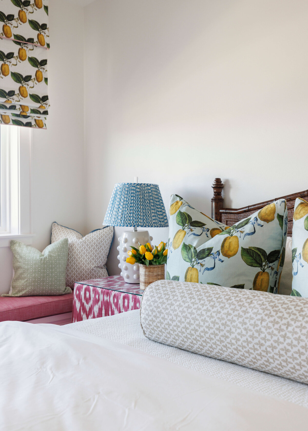 oyster creek studios lighthouse on the lake lemon pillow on white bed with red accent table in bedroom