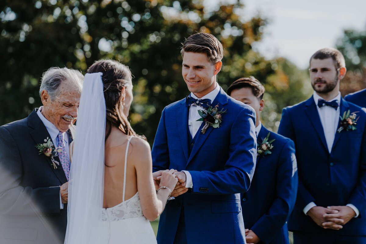 groomsmen looking at his bride during their ceremony
