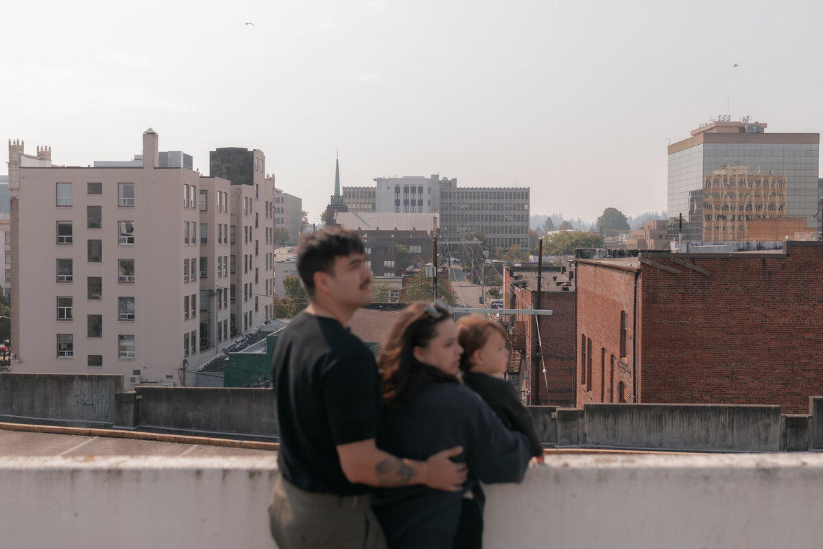 Family embracing in parking garage in city