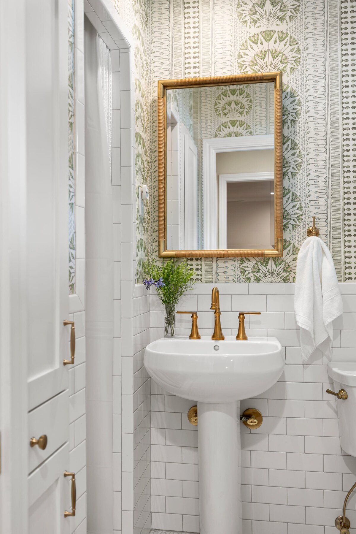 the keeping room interiors oakview half bath with gold faucet and green and white wallpaper