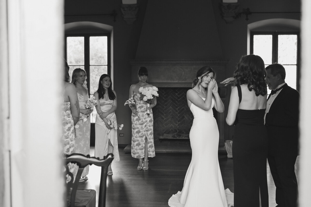 bride wiping her tears while giving her parents a letter