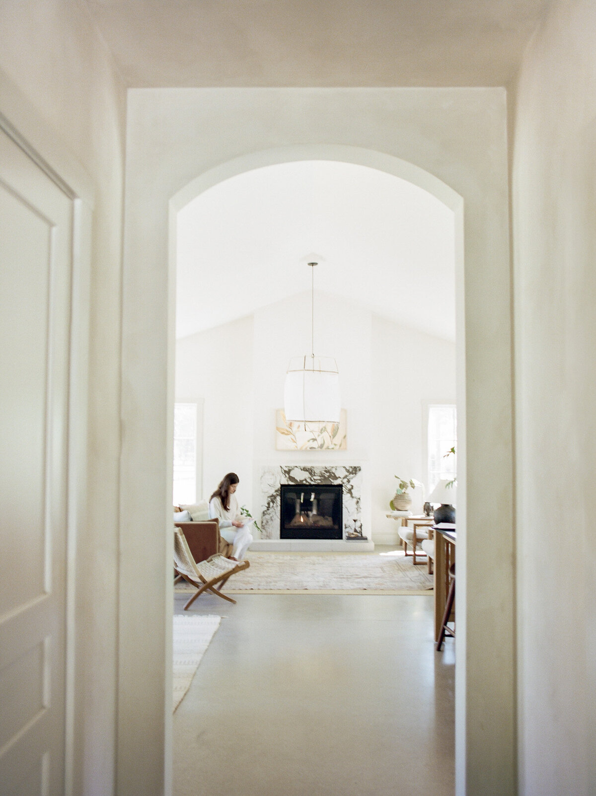 view under arch into living room at Fernhaus, designer branding photoshoot in Michigan