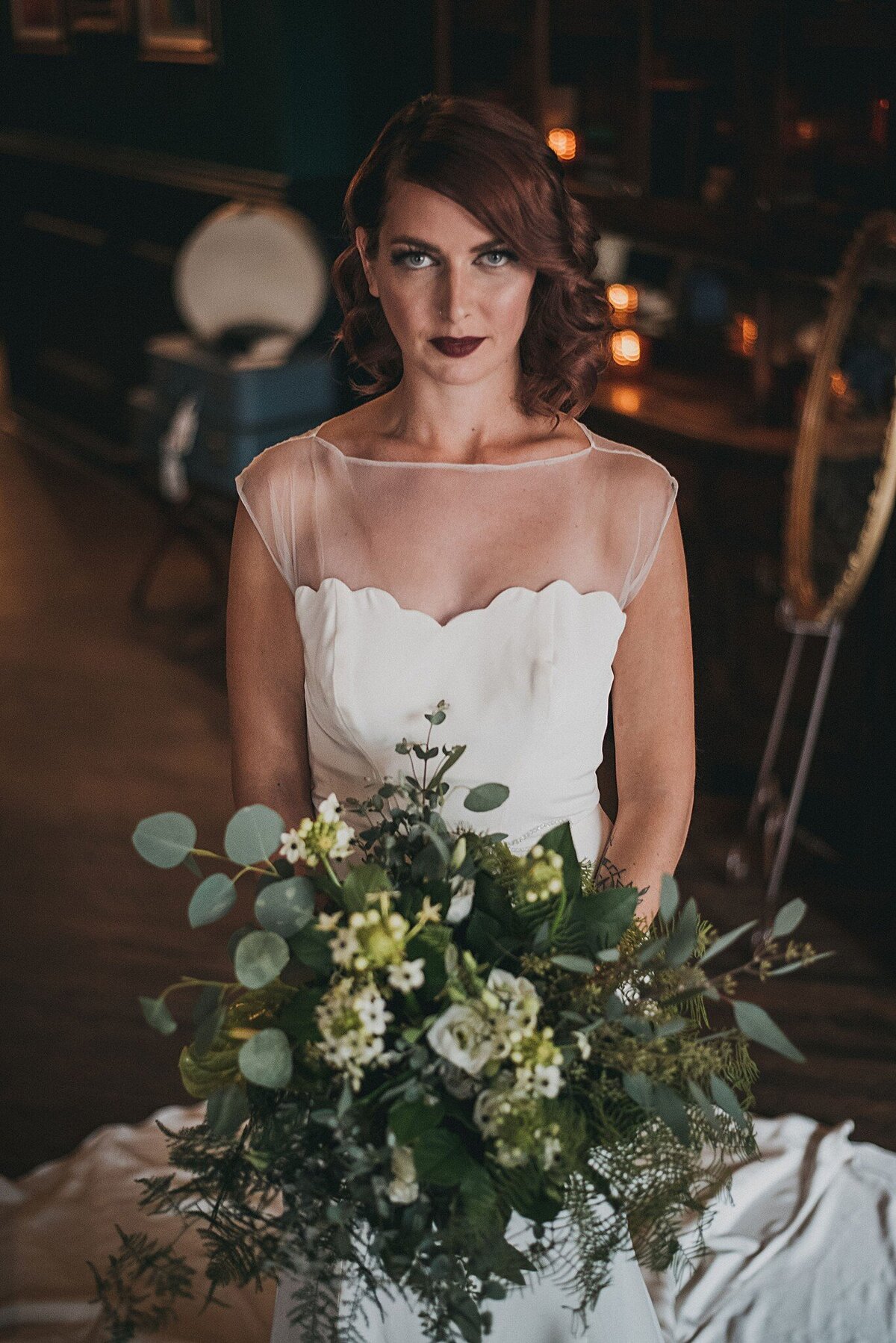 The Zara wedding dress style features a crepe bodice with a scalloped neckline that sits over the illusion bateau neckline.