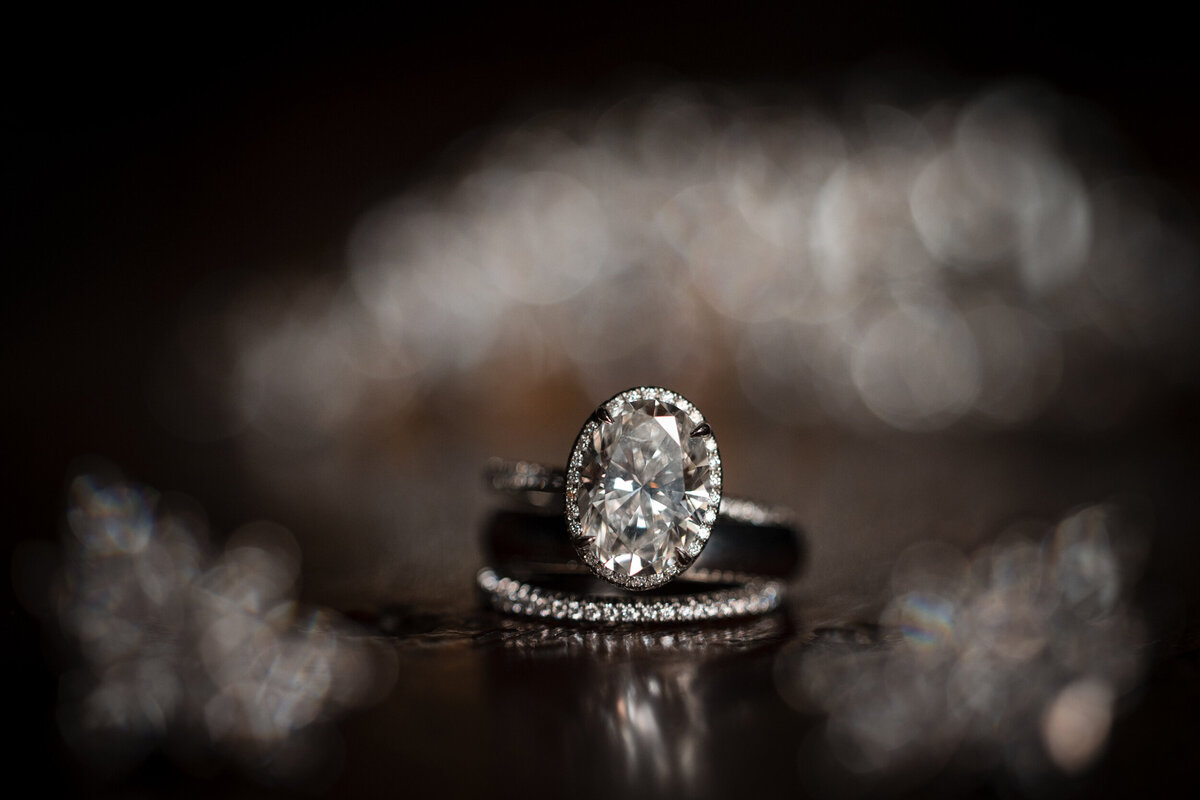 A wedding ring lays on a sparkly table at a destination wedding in Vermont