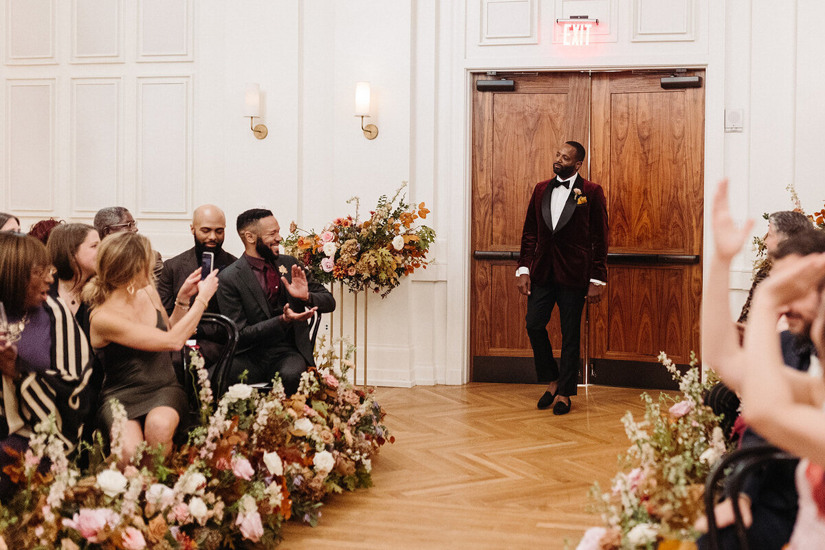 Lush aisle hedges line the entryway for this autumnal wedding with florals composed of roses, clematis, mums, delphinium, copper beech, and fall foliage creating hues of burgundy, dusty rose, copper, mauve, taupe, and lavender. Design by Rosemary and Finch in Nashville, TN.