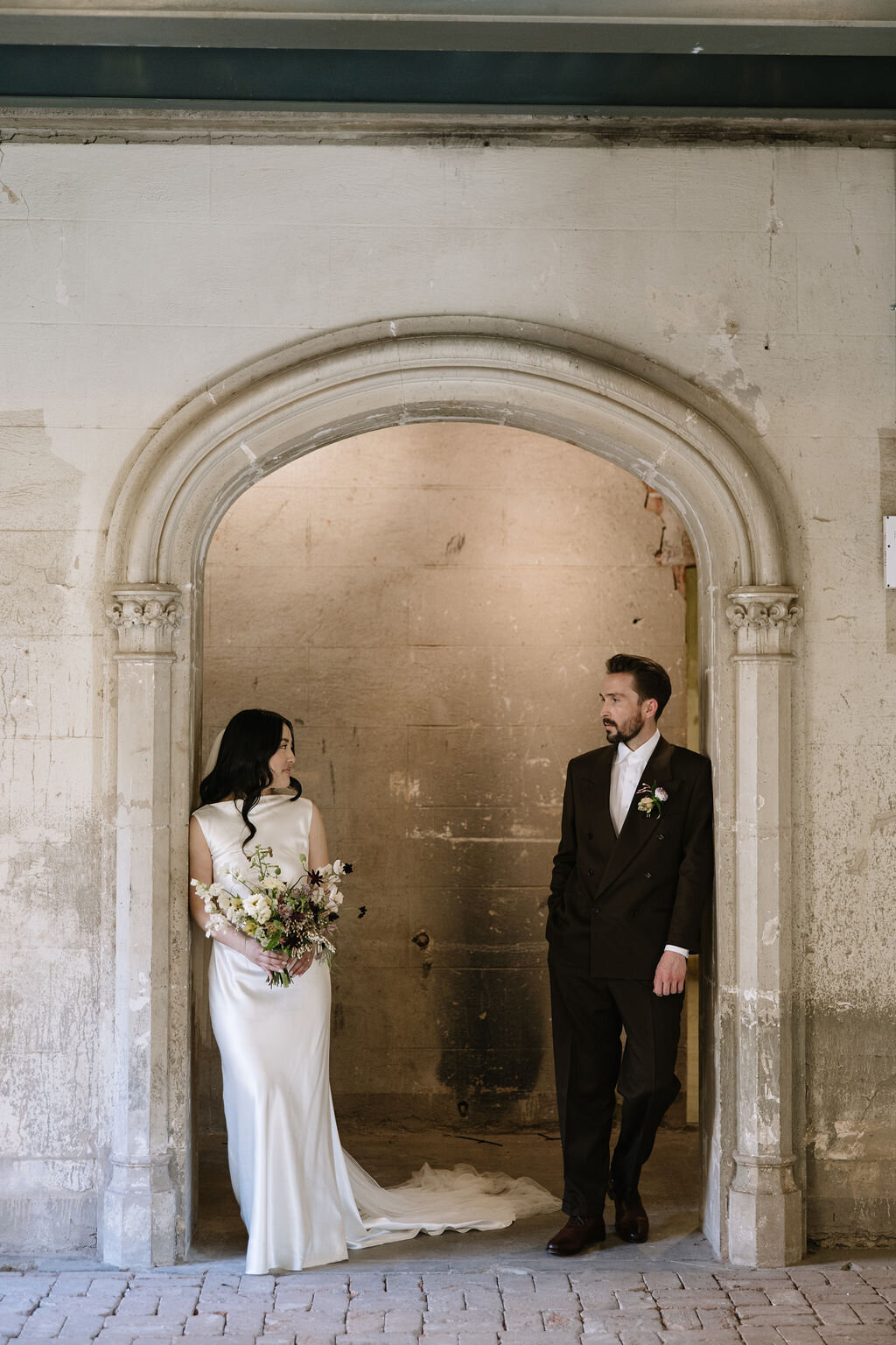 arched-entry-monroe-street-abbey-wedding-couple-portrait