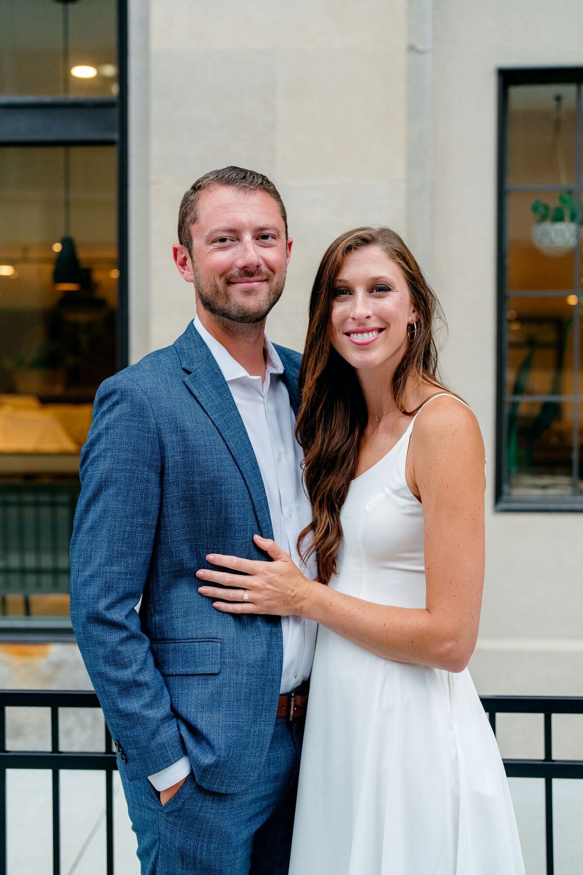 couple-smiling-arm-in-arm-urban-engagement