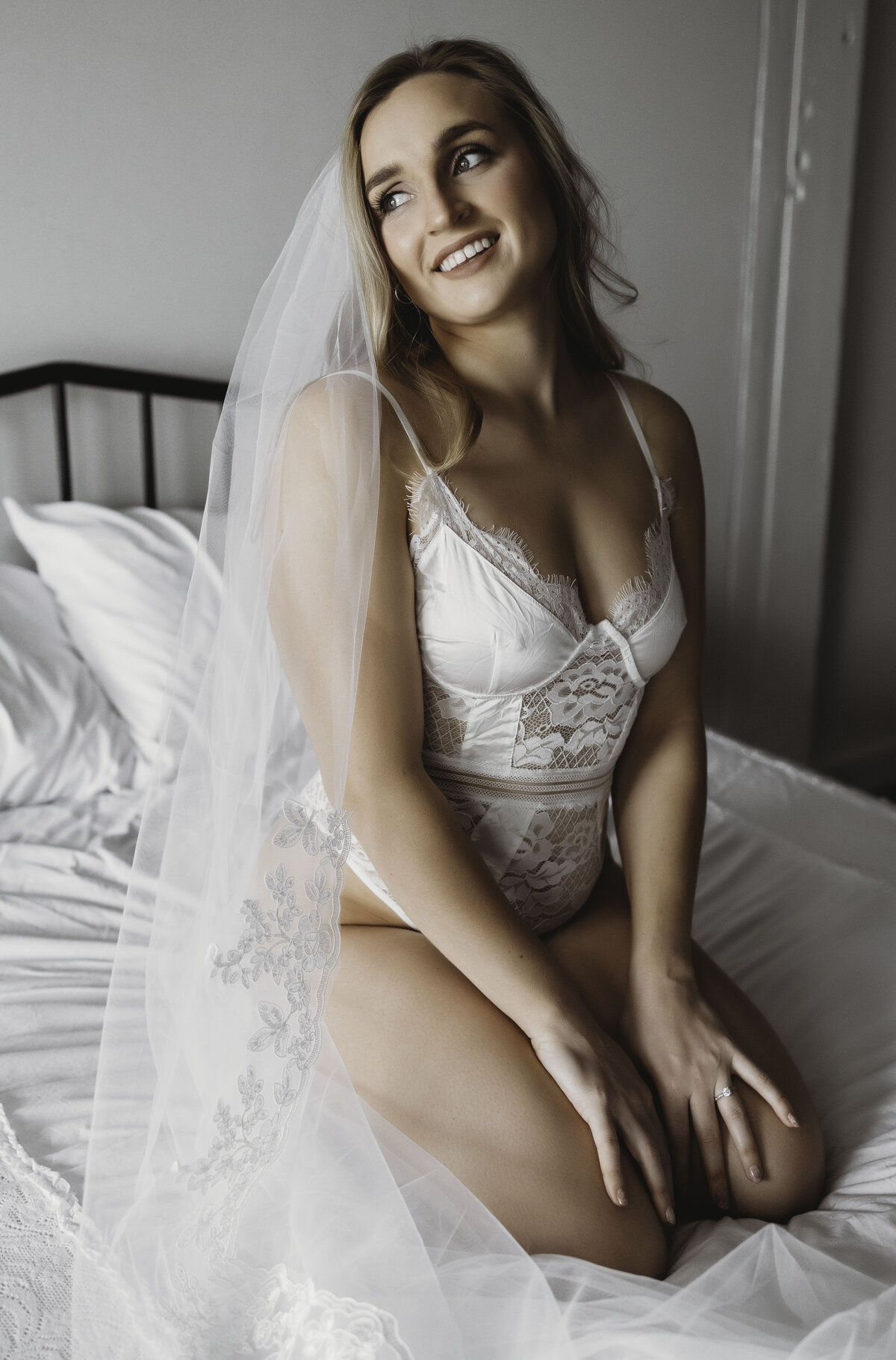 Woman in wedding lingerie wearing veil