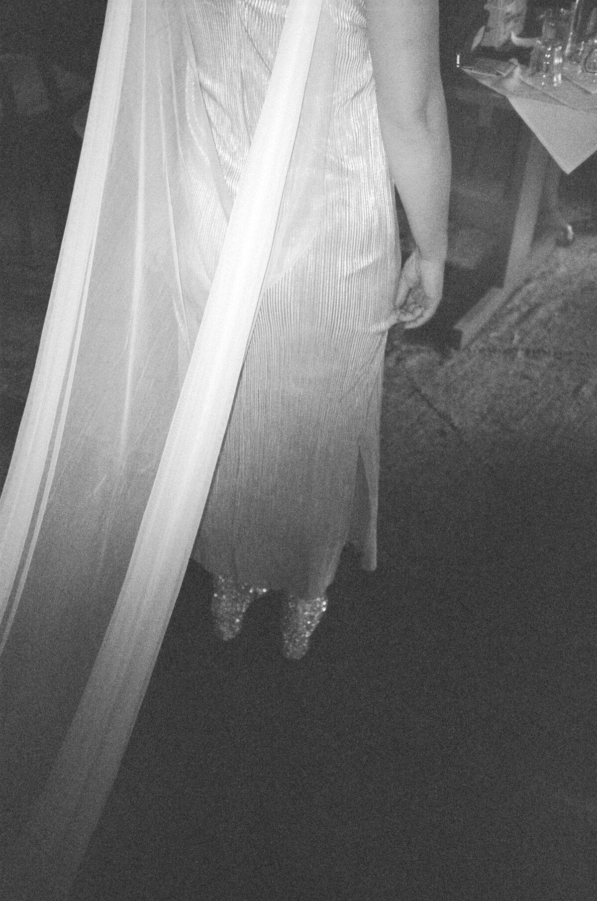 Bride caught on 35mm film wearing cape and sparkly shoes at The Corson Building in Seattle.