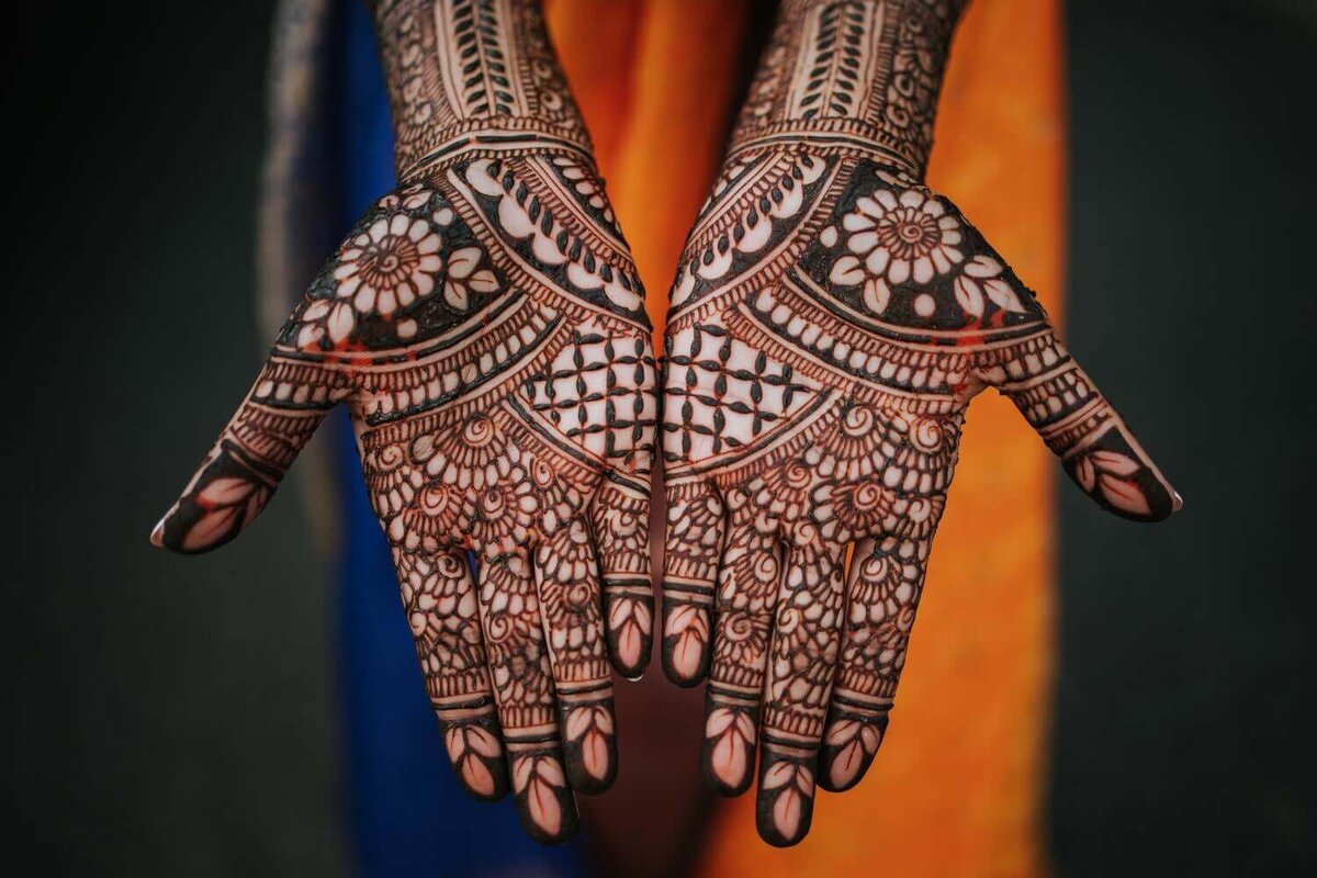 South Asian bride's palms covered in beautiful bridal mendhi.