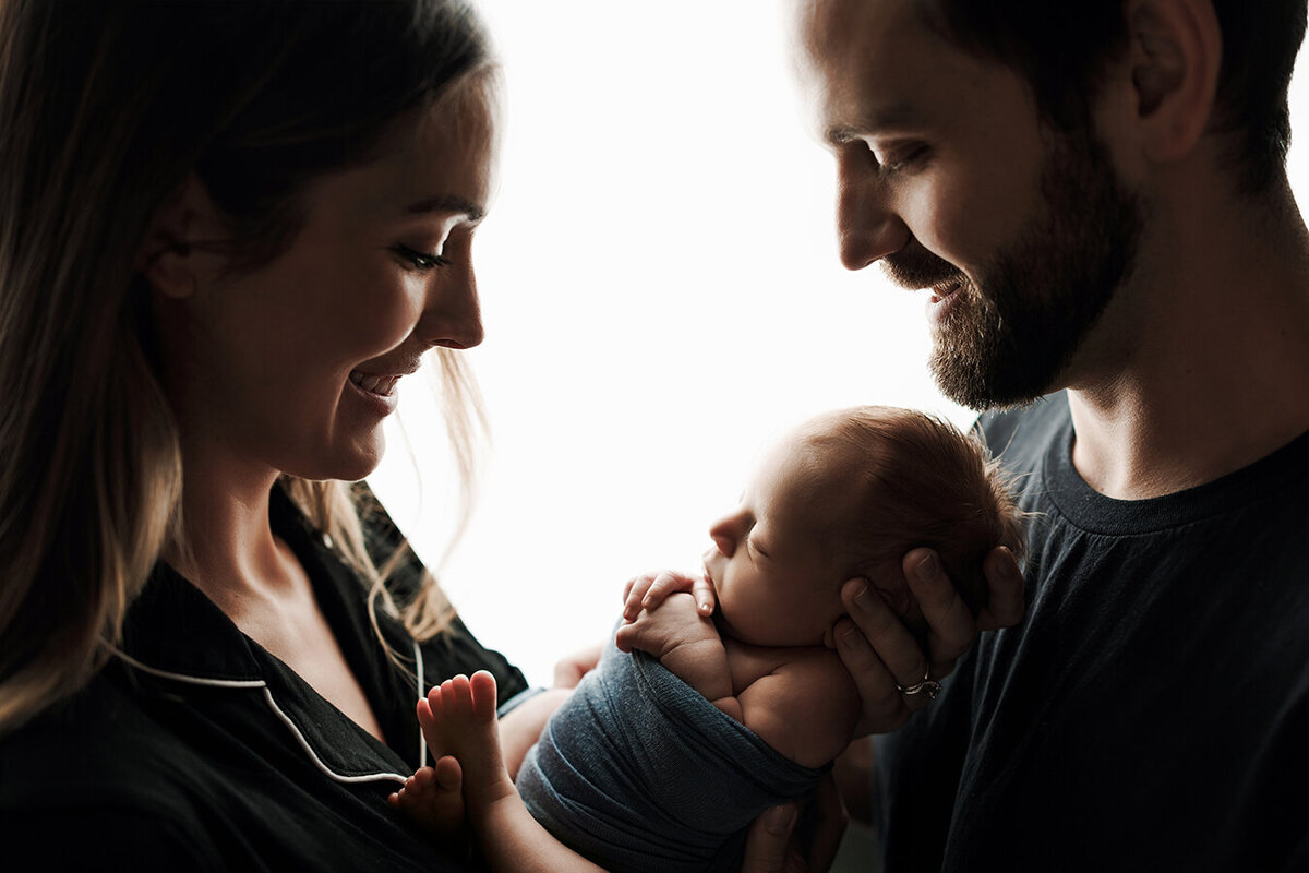 Gorgeous Fort Collins family holding their newborn baby boy for a photograph