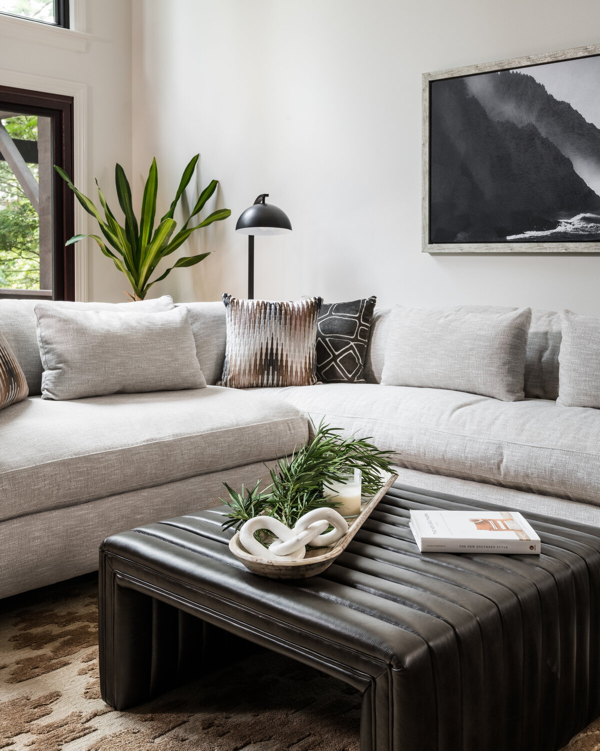 Contemporary living room in Lake Norman, NC, featuring a stylish coffee table with curated decor.