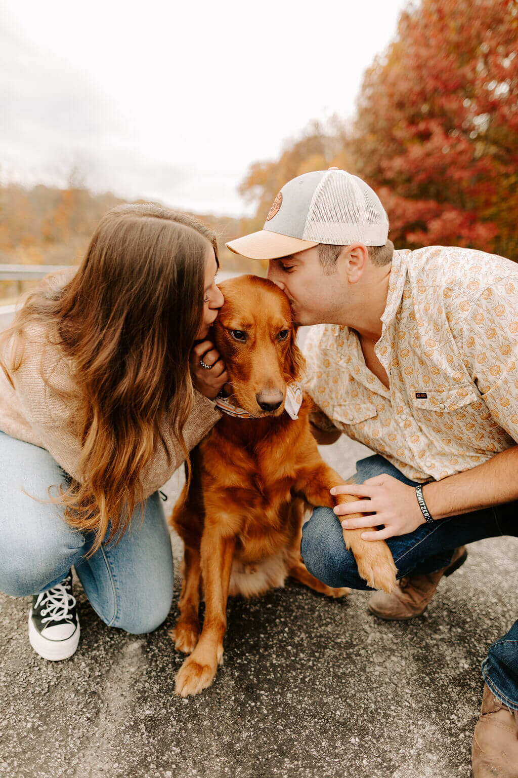 couple posing with dog