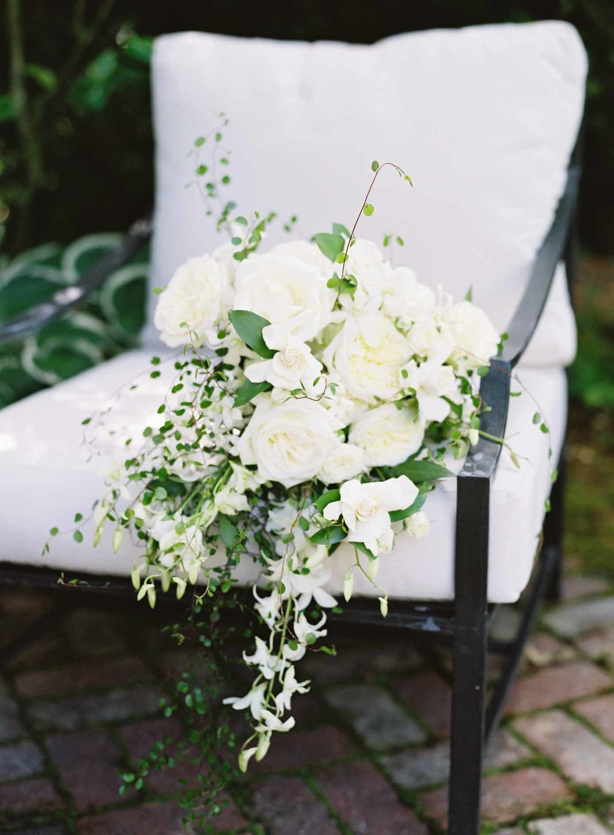 Lovely white cascade bouquet with orchids and gardenias.