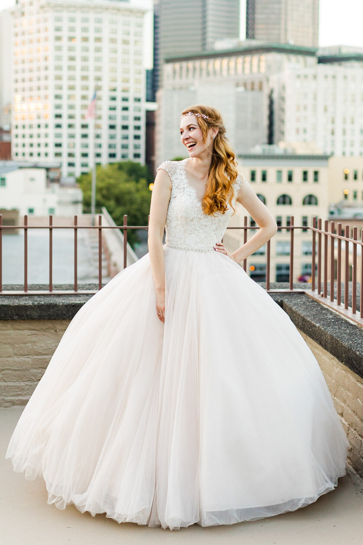 Bride-laughing-in-princess-ballgown-wedding-dress-on-Seattle-urban-rooftop-at-Pioneer-Square-photo-by-Joanna-Monger-Photography