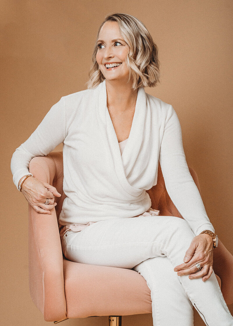 Stunning example of a Charleston headshots photoshoot where a women dressed in all white lights up the frame with her smile. This Charleston photo studio captured this moment perfectly.