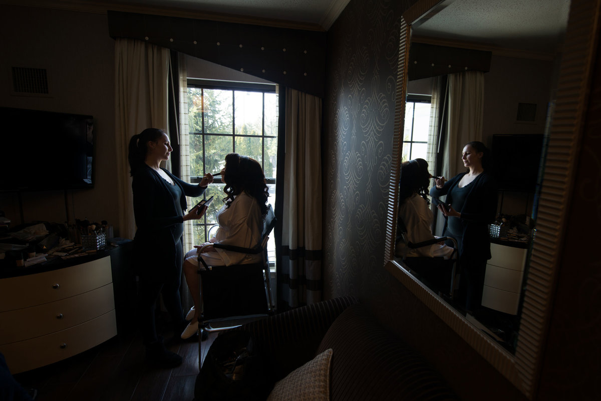 Bride getting makeup done at The Inn at Fox Hollow
