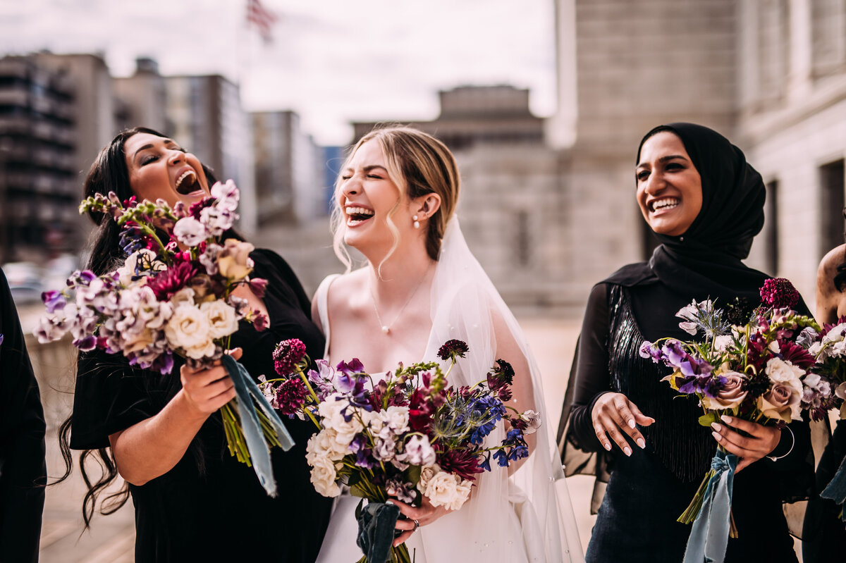 winter bride laughing with bridemaids