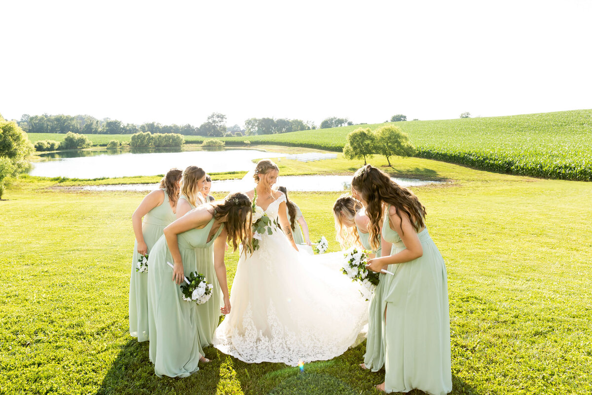 Bride with bridesmaids wearing pale green dresses at  Ruby Cora wedding venue in Clarksville, TB