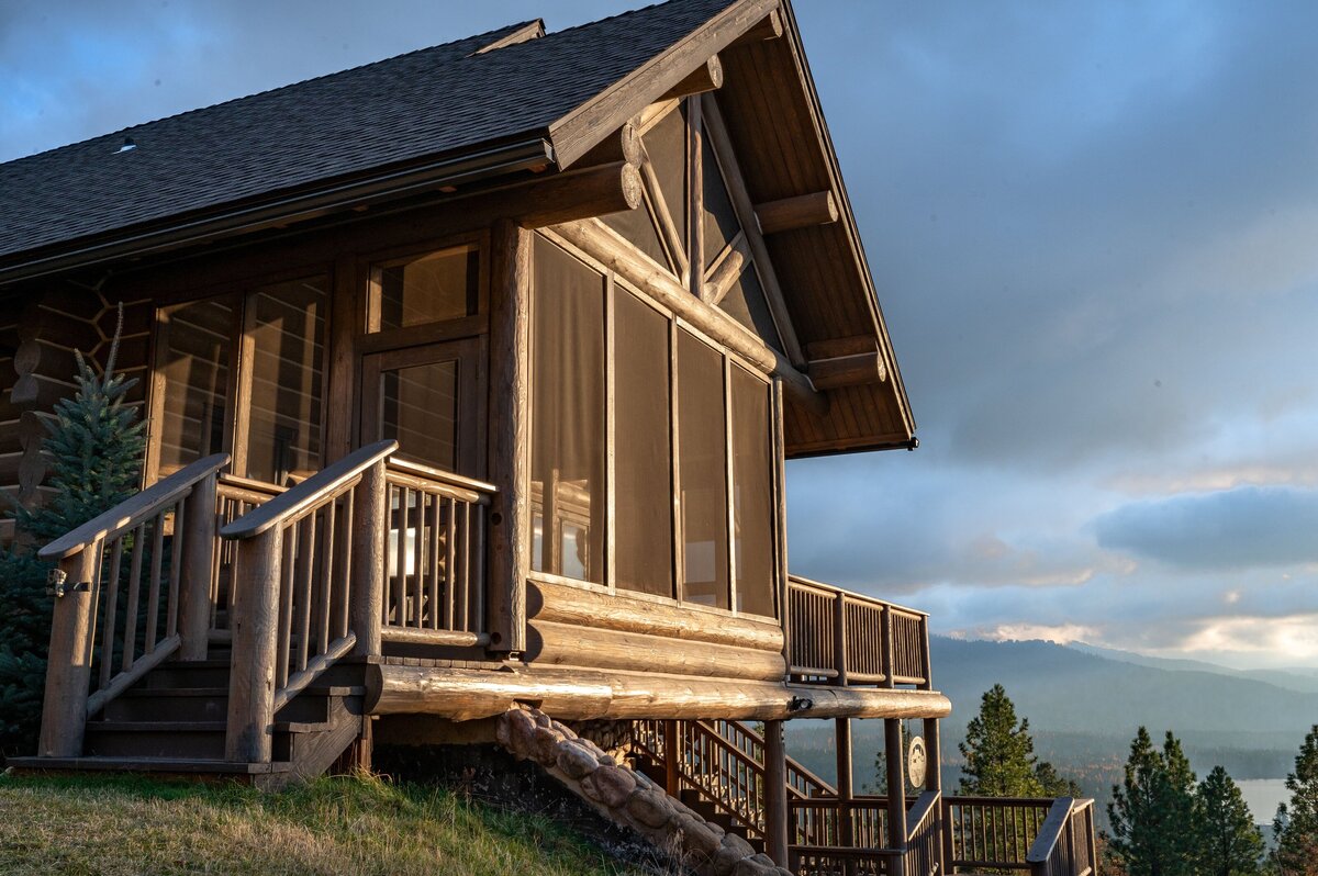 Rustic log cabin with a large porch and mountain views, Photo by Moore Creative.