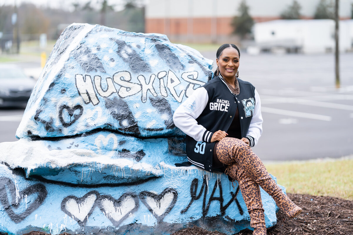 50th milestone birthday photoshoot woman wearing letterman jacket