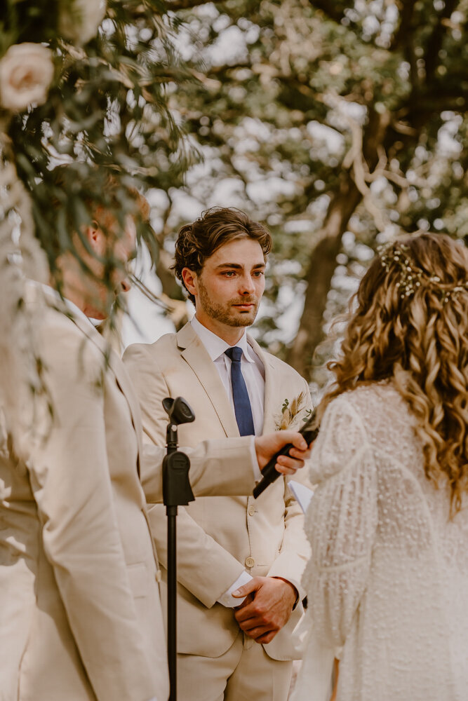 wedding-ceremony-groom-crying-during-vows--iowa-des-moines-wedding-photographer-storyteller-collective-photo-co