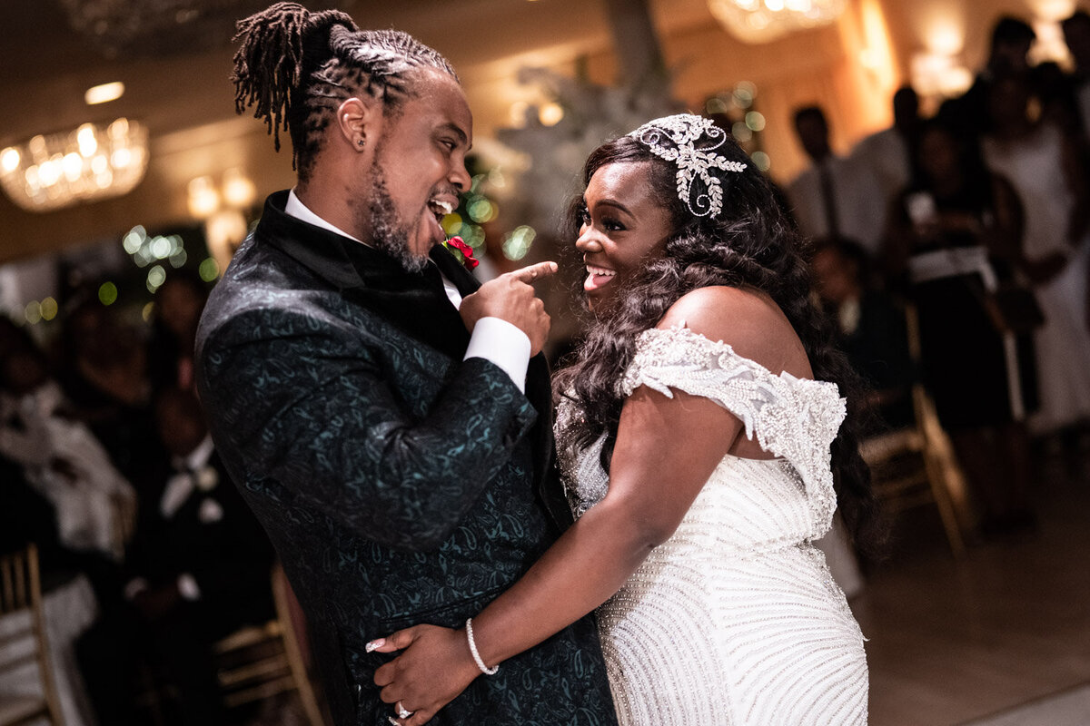 Bride and groom smile at each other during first dance at Southern Oaks