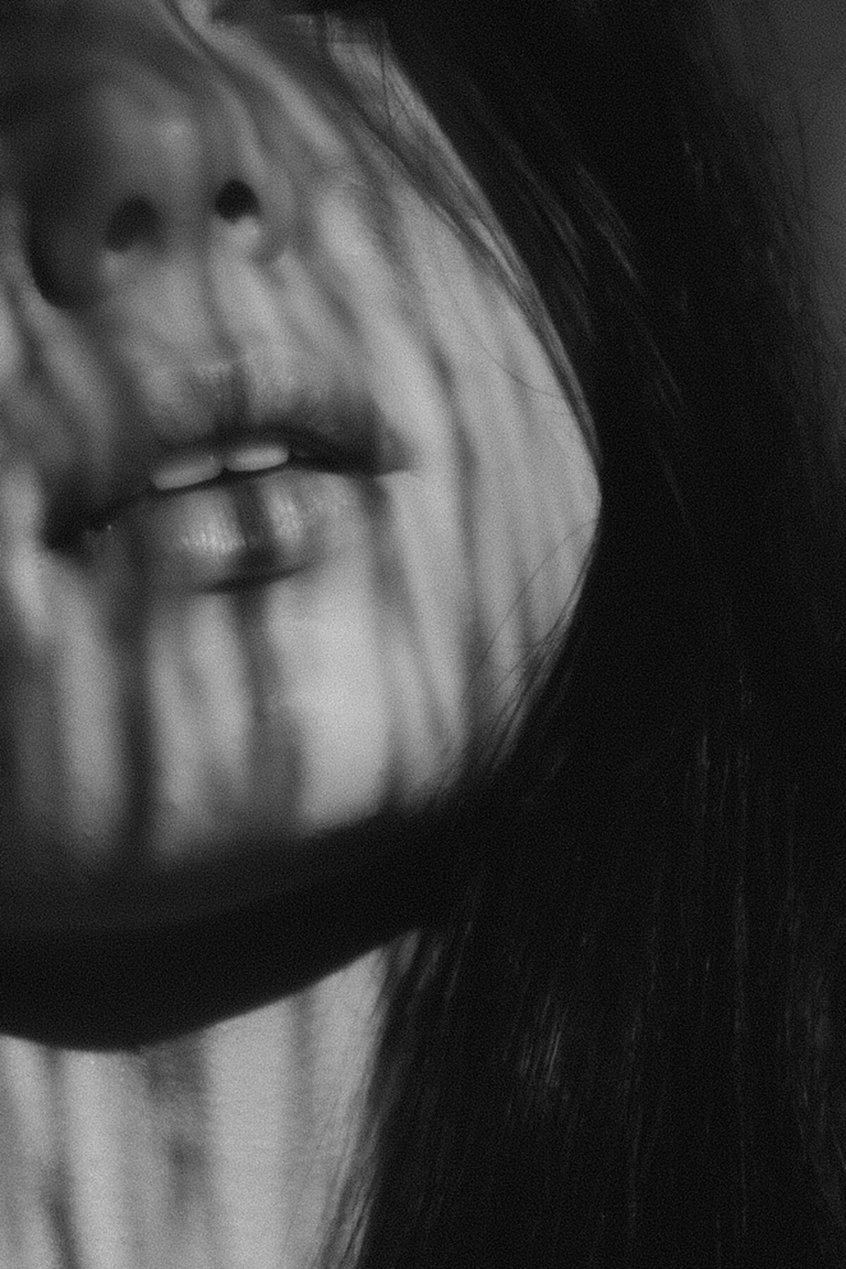 Creative play using light and shadow in black and white, close up of models face. Captured by Sunshine Coast Brand Photographer