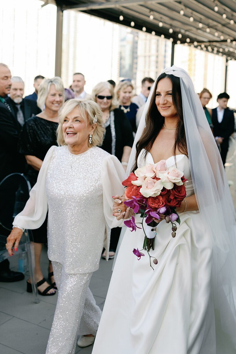 bride walking down aisle with mom to show penthouse at riverside wharf photos