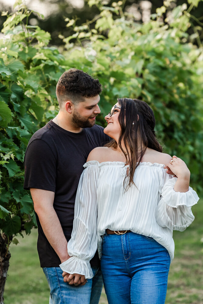 Couple gazing into each others eyes in a vineyard