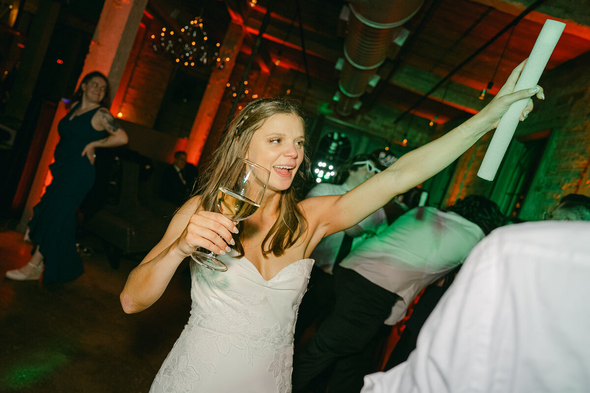 Bride toasting with champagne during San Antonio wedding reception at The Battalion