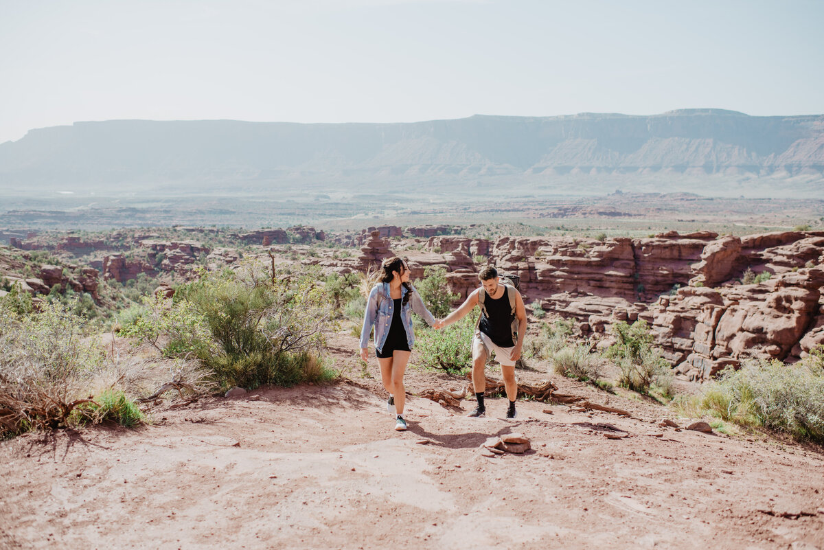 Utah Elopement Photographer captures man and woman walking through Moab