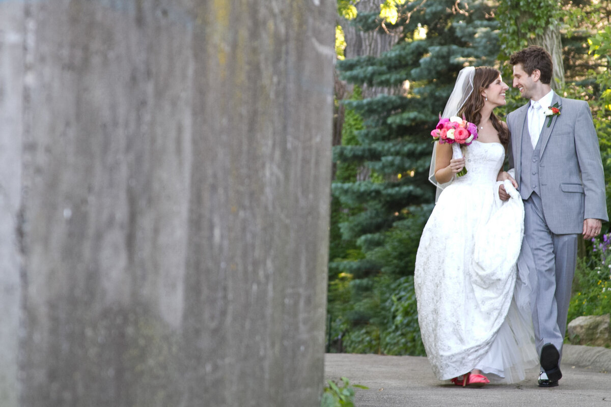 njeri-bishota-lauren-ashley-bride-groom-walking-outdoors-flowers-dress-pink-shoes