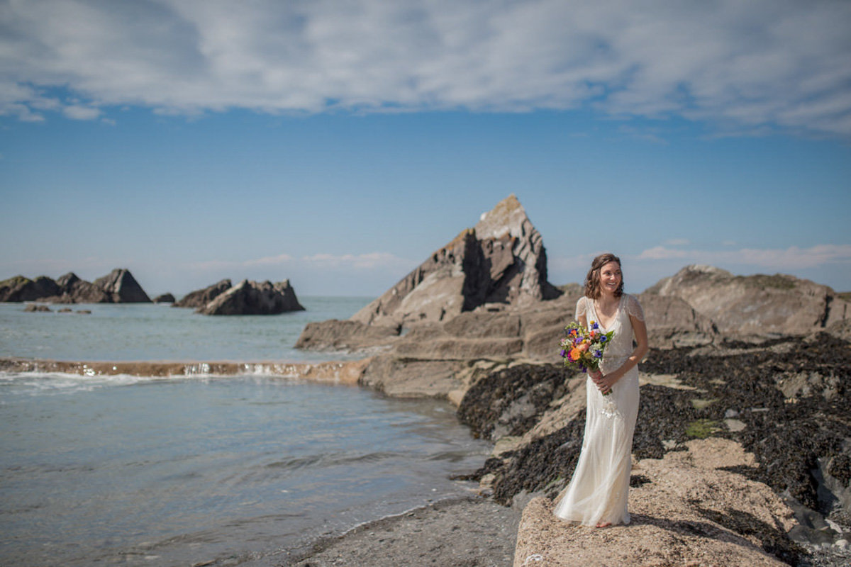 Bride by tidal pools at Devon Beach Wedding Tunnels Beaches