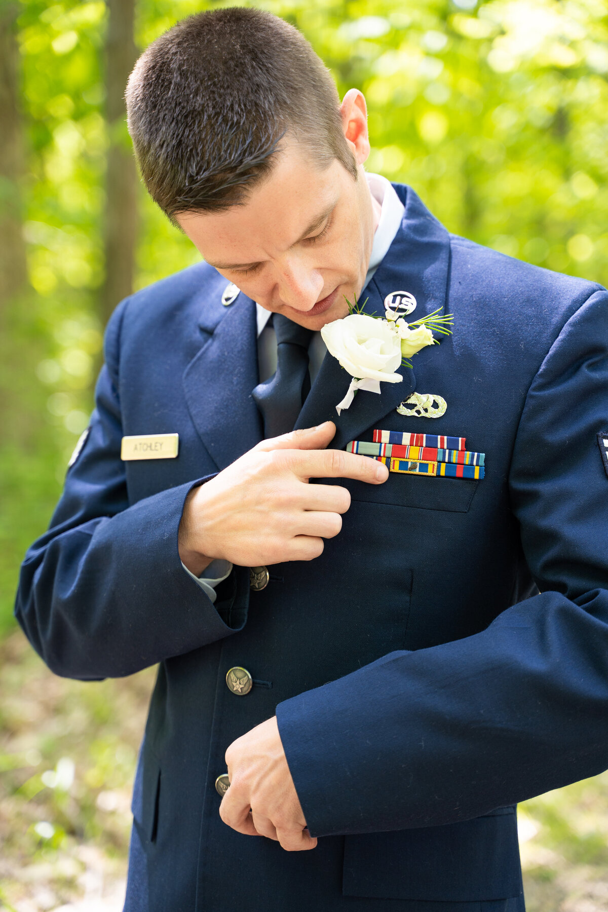 The groom, Beau Atchley, in his military uniform describing the meaning of the symbols on his jacket are at his wedding at Cheers Chalet in Lancaster, Ohio.