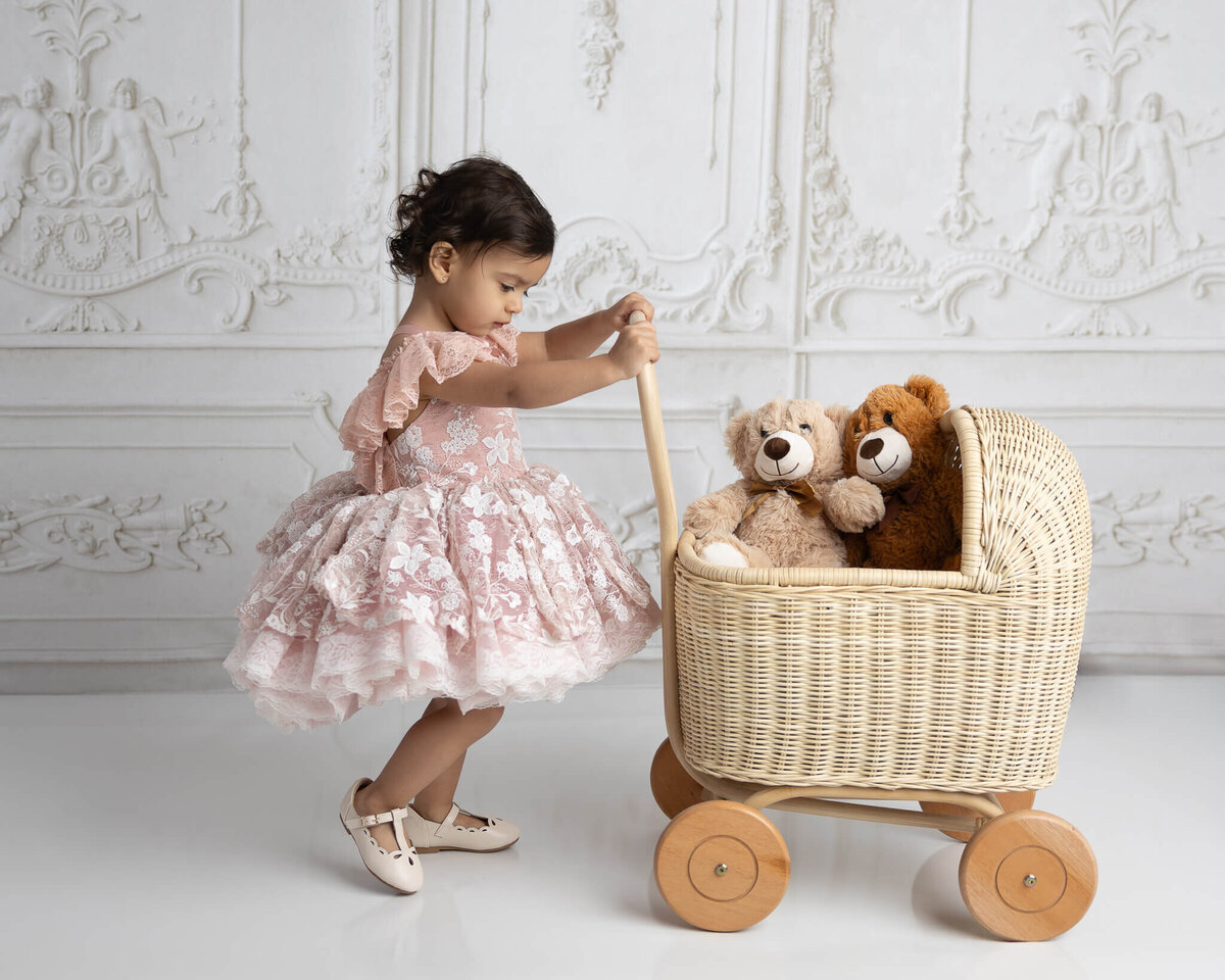 child pushing play stroller during photography session near san antonio