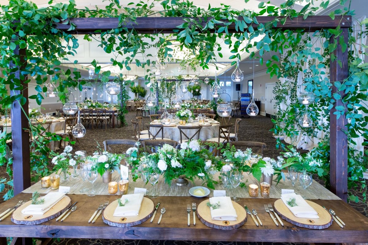 greenery trellis and greenery centerpieces for wedding reception at Newcastle Golf Club