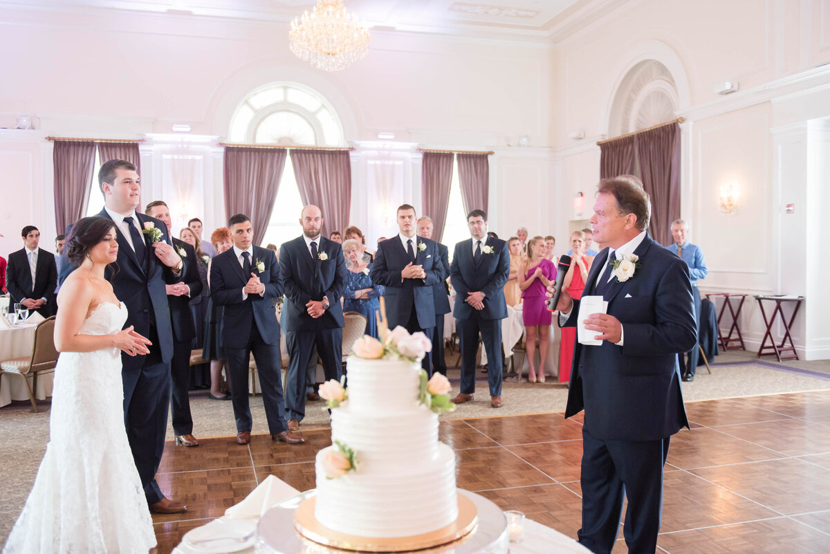 dad giving a wedding toast while standing near the cake in the ballroom at university club pittsburgh