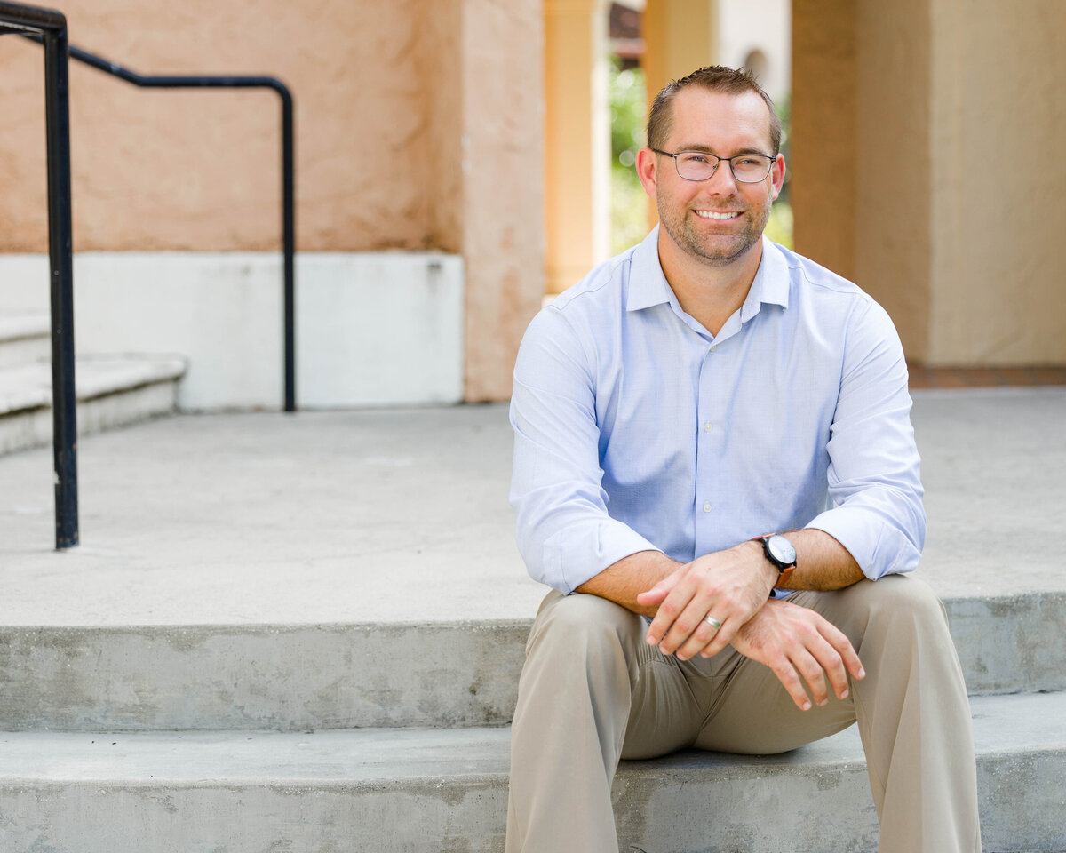 Guy sitting on stairs anniversaryby Lucas Mason Photography in Orlando, Windermere, Winder Garden area