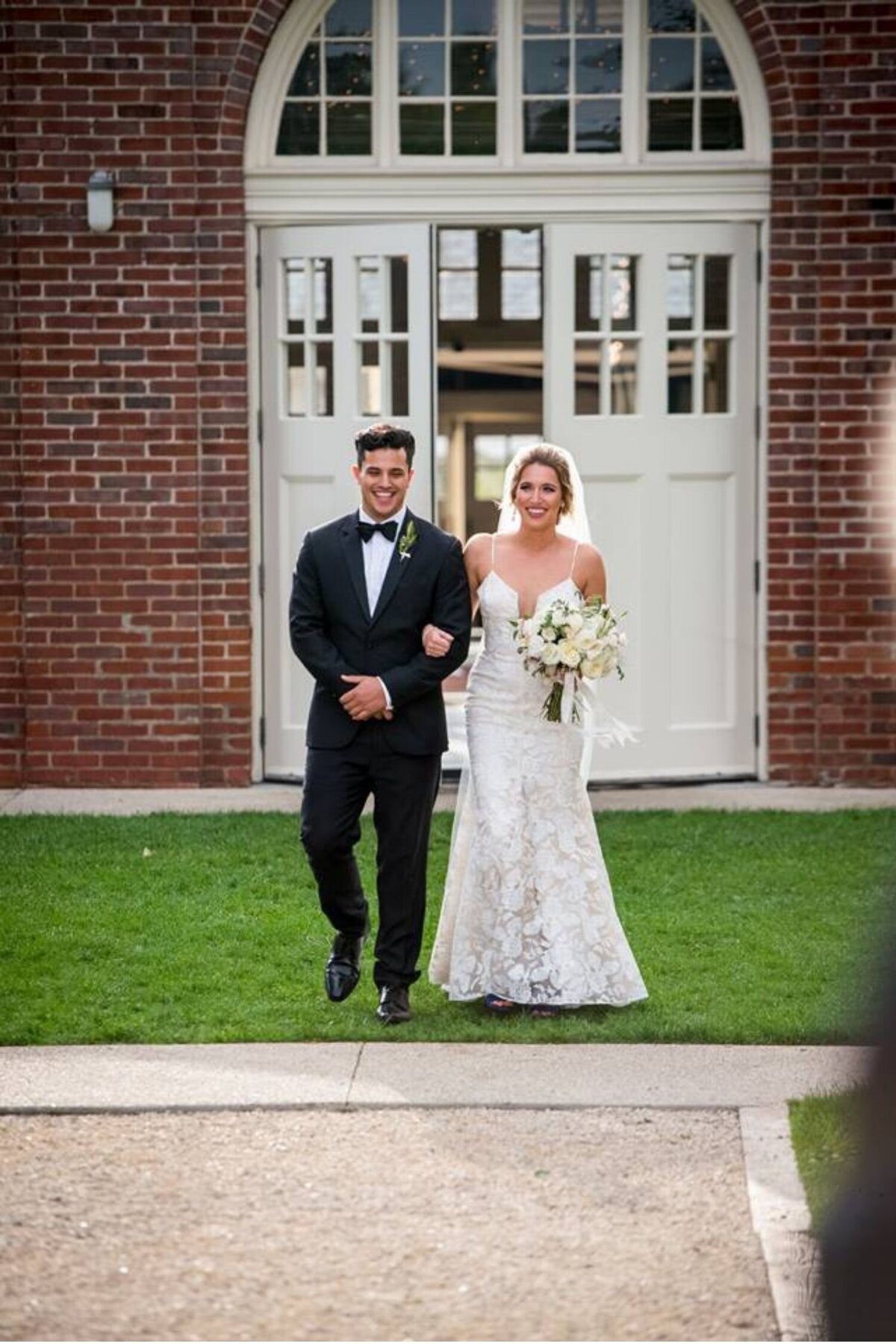Brother walks sister down the aisle during an outdoor ceremony at a luxury Italian inspired Chicago North Shore wedding.