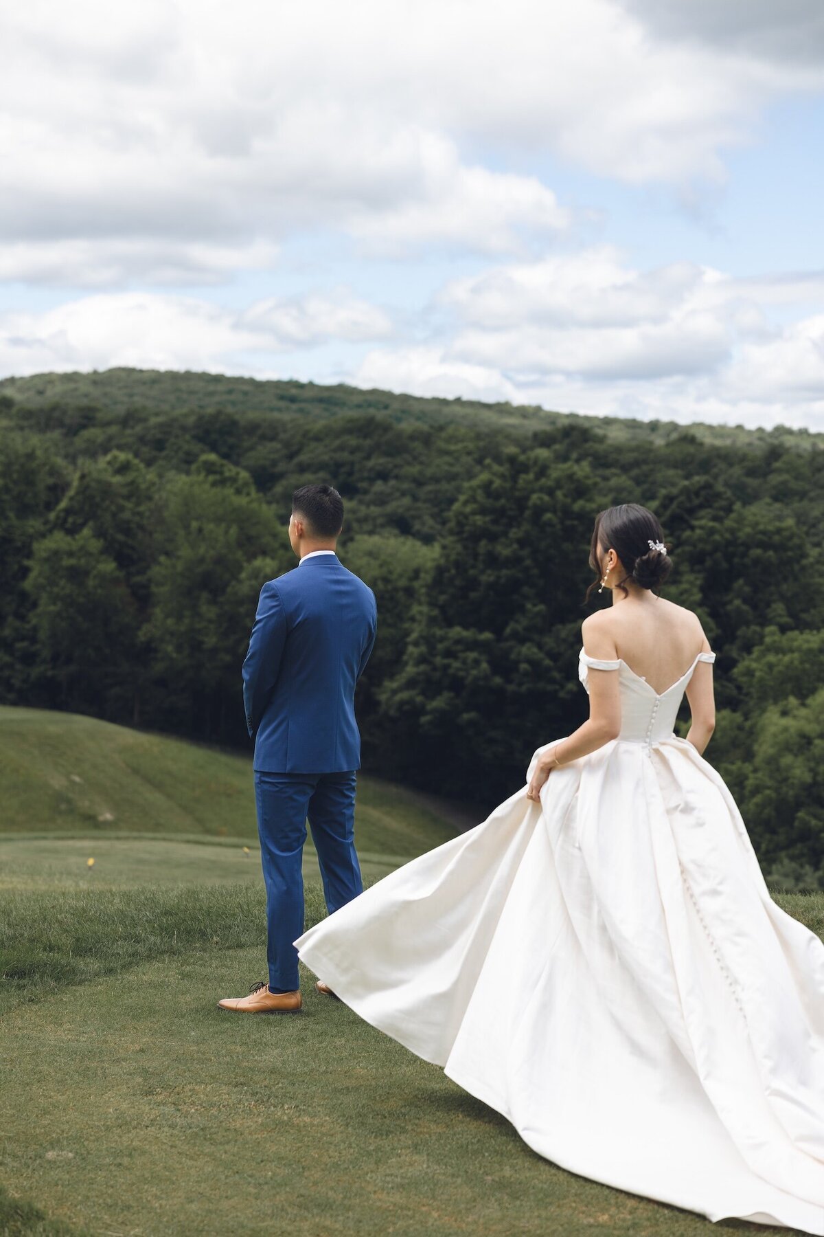 Bride and groom first look on manicured golf course at Crystal Springs Resort
