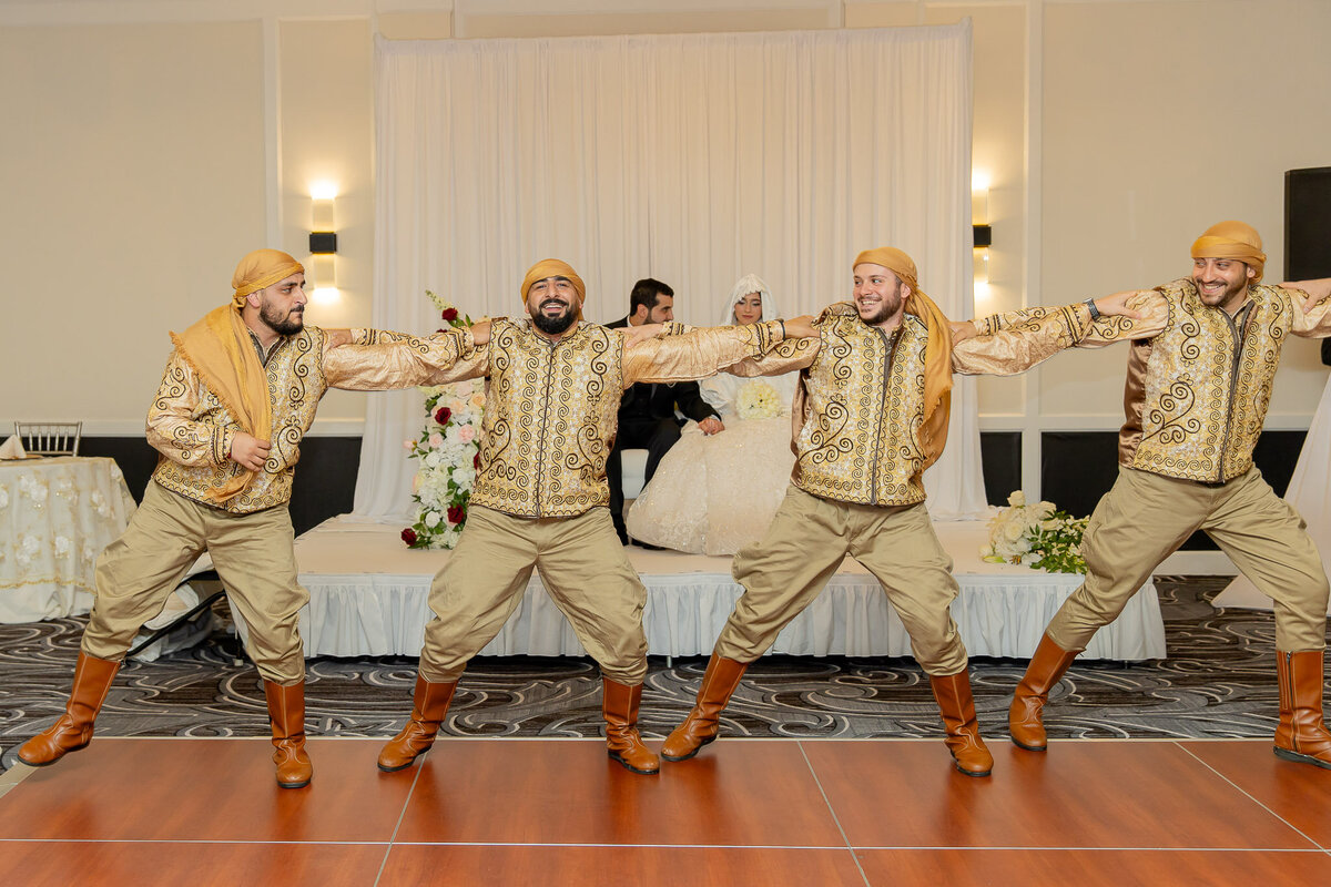 Groomsmen and the groom performing a dance at their wedding reception in Raleigh NC.