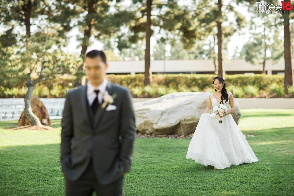 Bride approaches Groom from behind during the first look